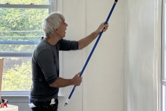 Peter Gauthier rolling on a fresh coat of paint