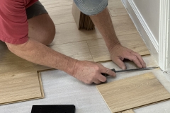 Bill Roberts laying new flooring