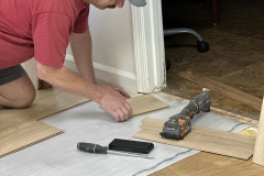 Bill Roberts laying new flooring