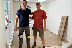 Toby Glaza and Bill Roberts laying new flooring