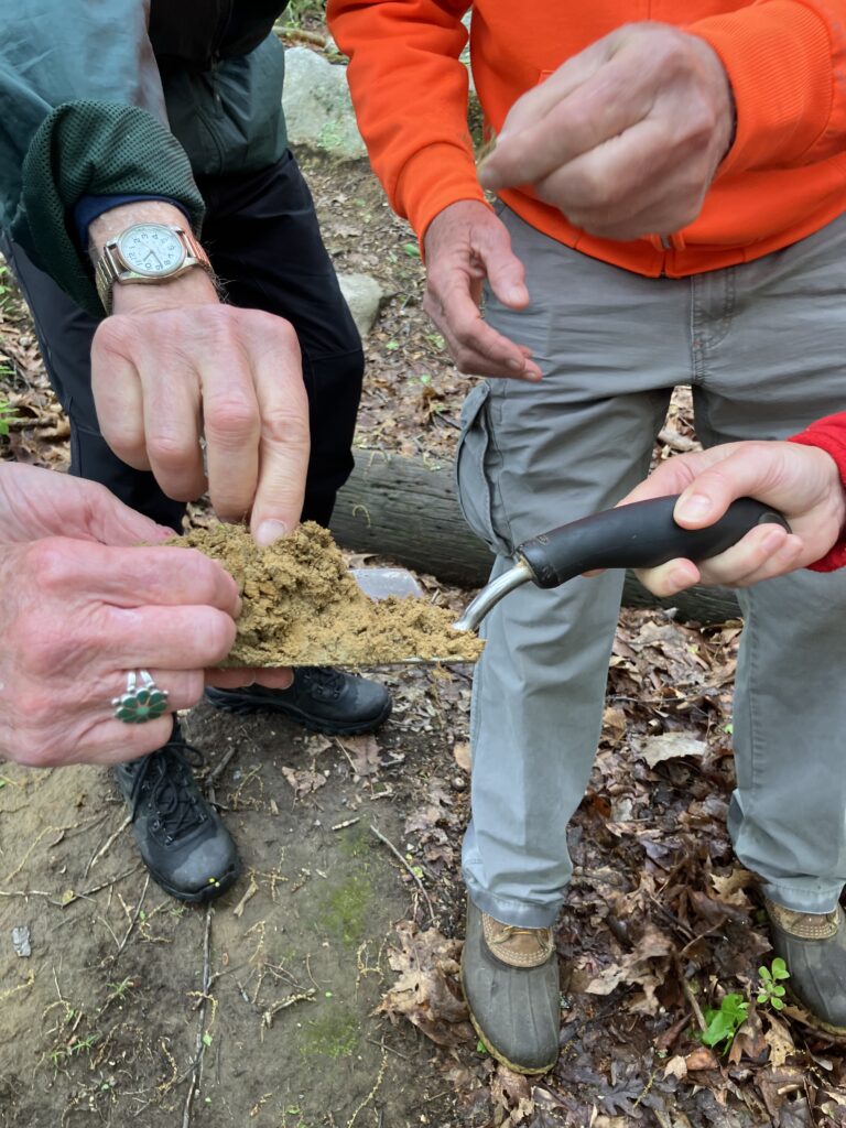 Mary offers silt for participants to touch